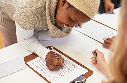 Woman adding her name to a list