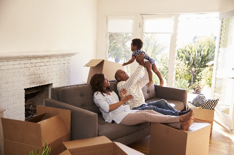 Family with empty boxes in new house